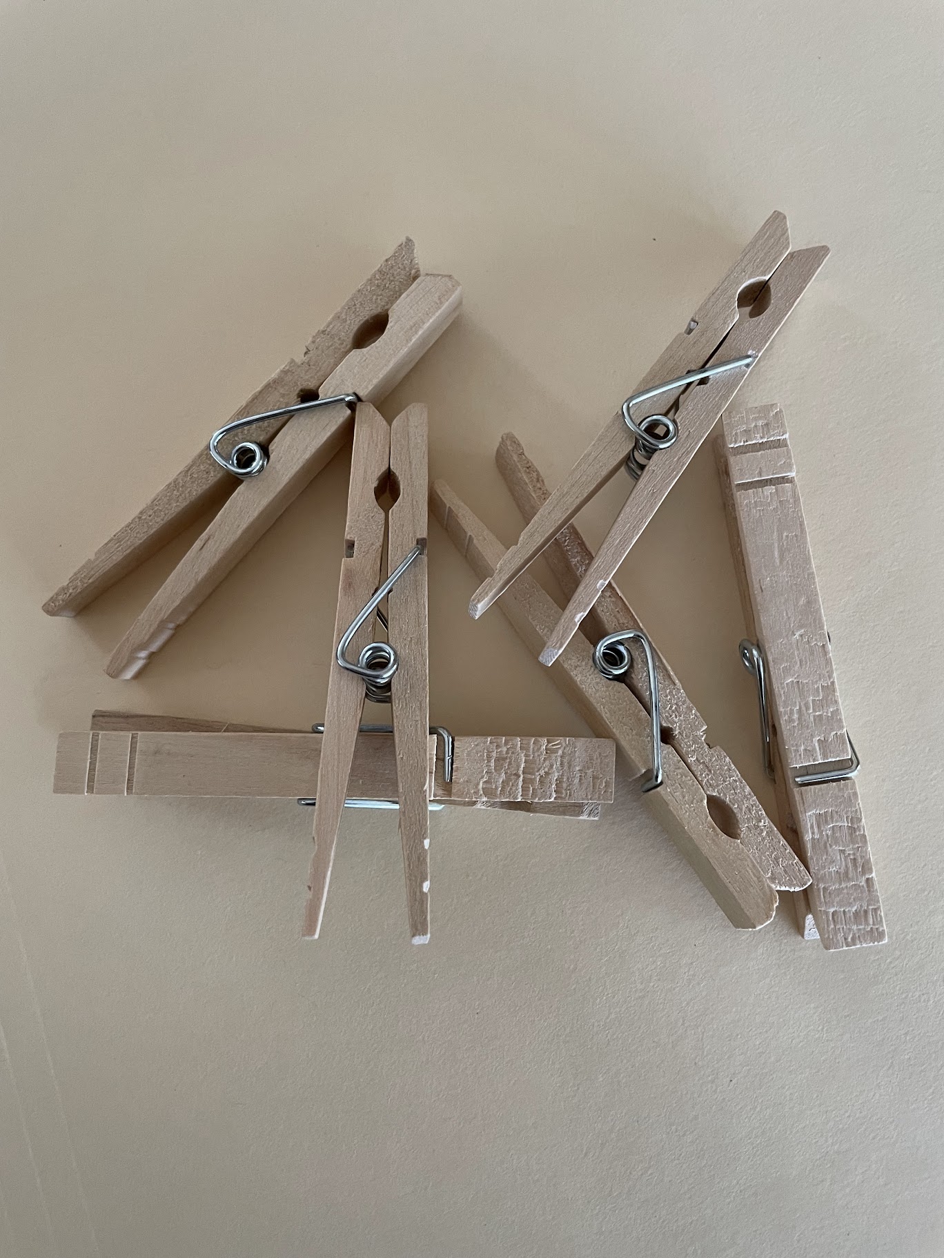 A small pile of wooden clothespins on a tabletop